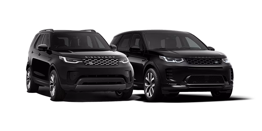 Two black Land Rover Discovery family SUVs side by side showcasing their distinct front designs