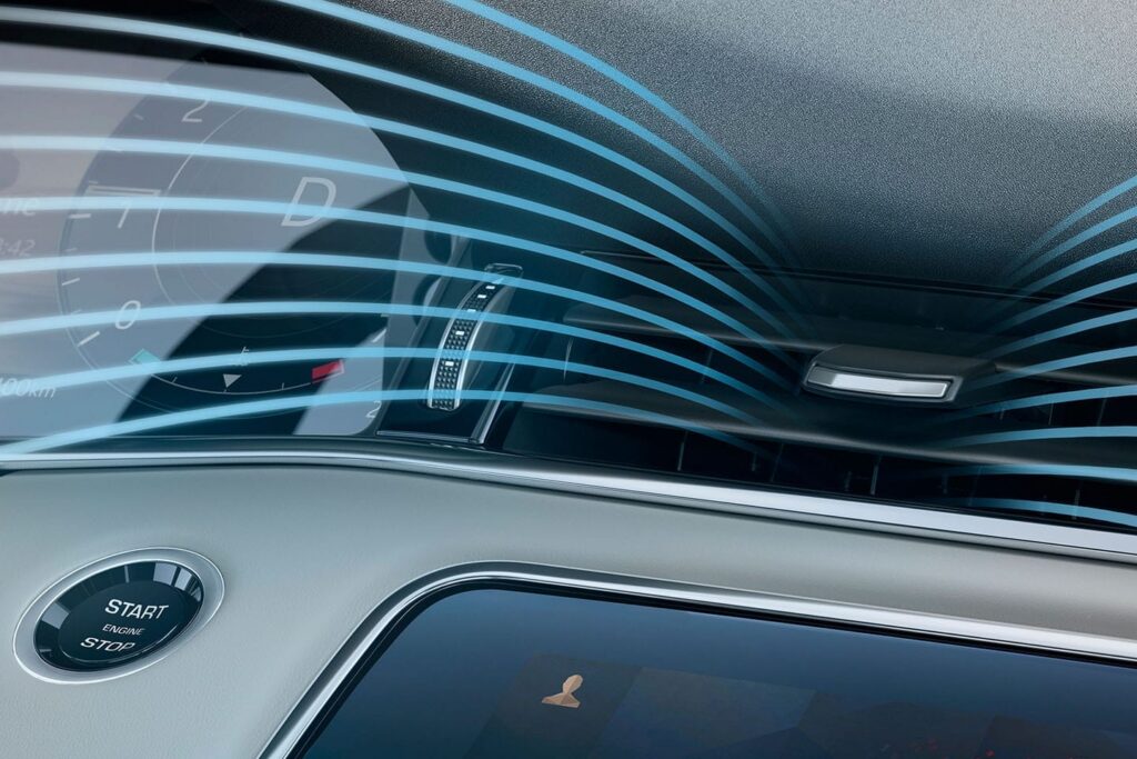 Close-up of car dashboard air vent showing blue airflow lines emphasising active ventilation inside vehicle