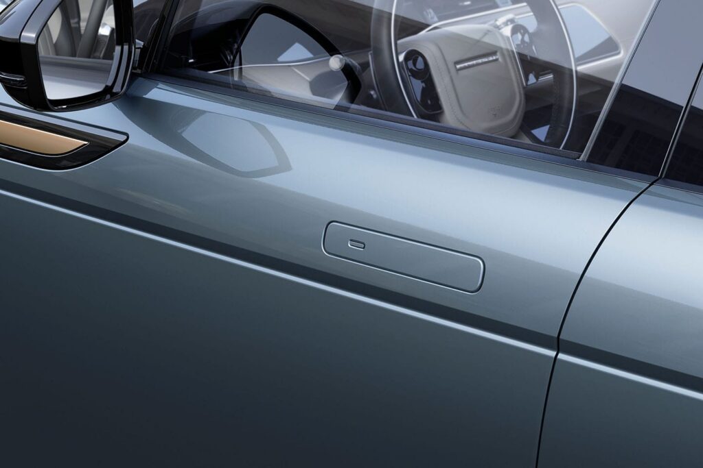 Close-up of a sleek electric car door handle on a modern vehicle highlighting minimalist design features