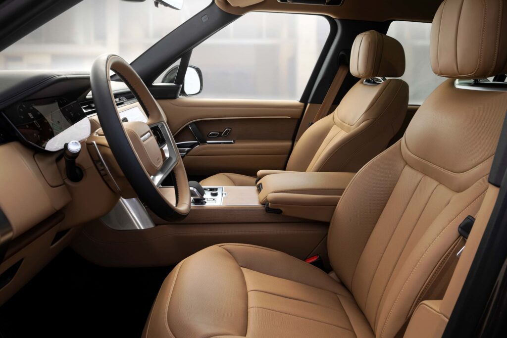 Tan leather seats and a modern dashboard inside a luxury car showcasing a premium interior design
