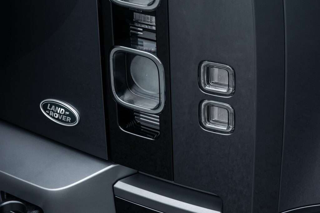 Close-up of a Land Rover vehicle showing rear light clusters and the Land Rover badge on the back panel