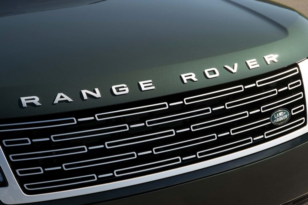 Close-up view of a Range Rover dark green bonnet and front grille with the Land Rover badge visible