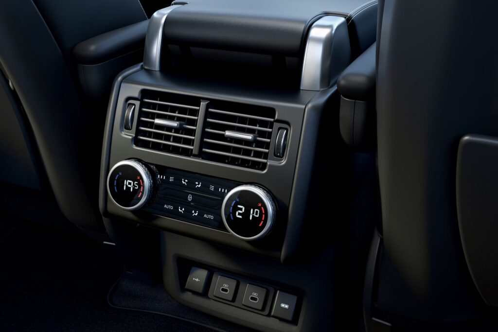 Rear view of car climate control panel showing temperature dials set at 19.5 and 21.0 degrees and dual USB charging ports